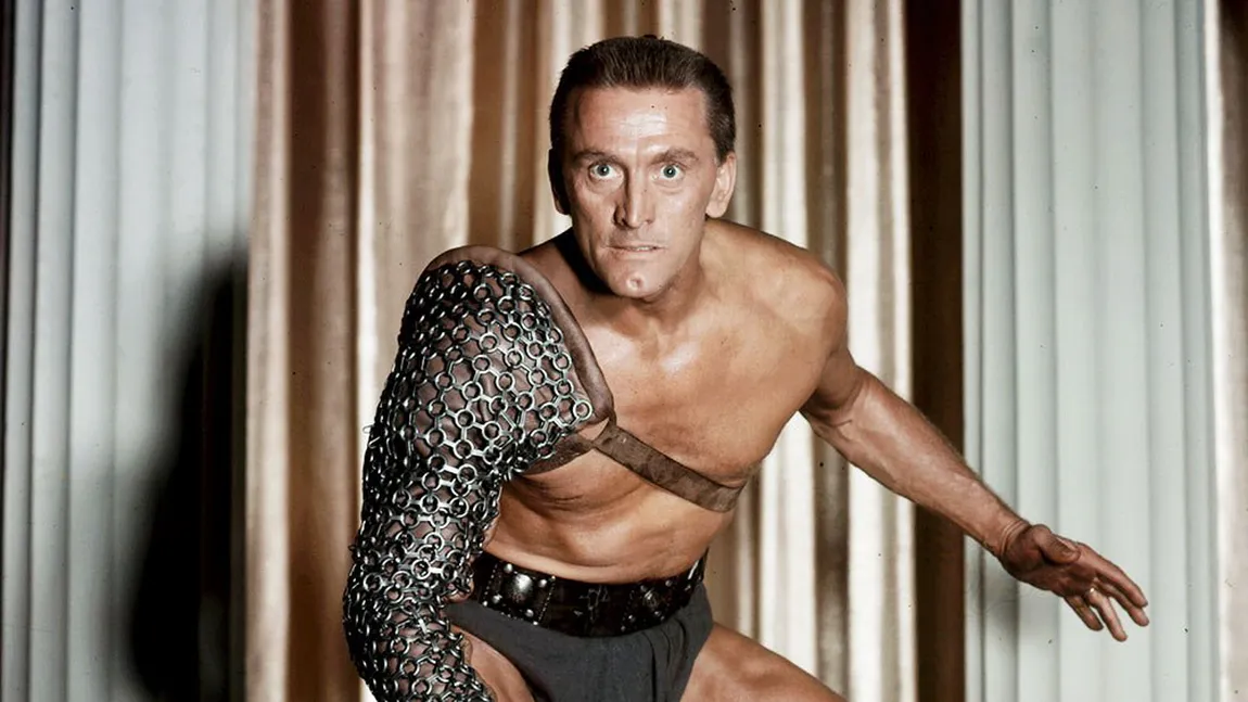 Kirk Douglas, scos la plimbare în scaunul cu rotile. 