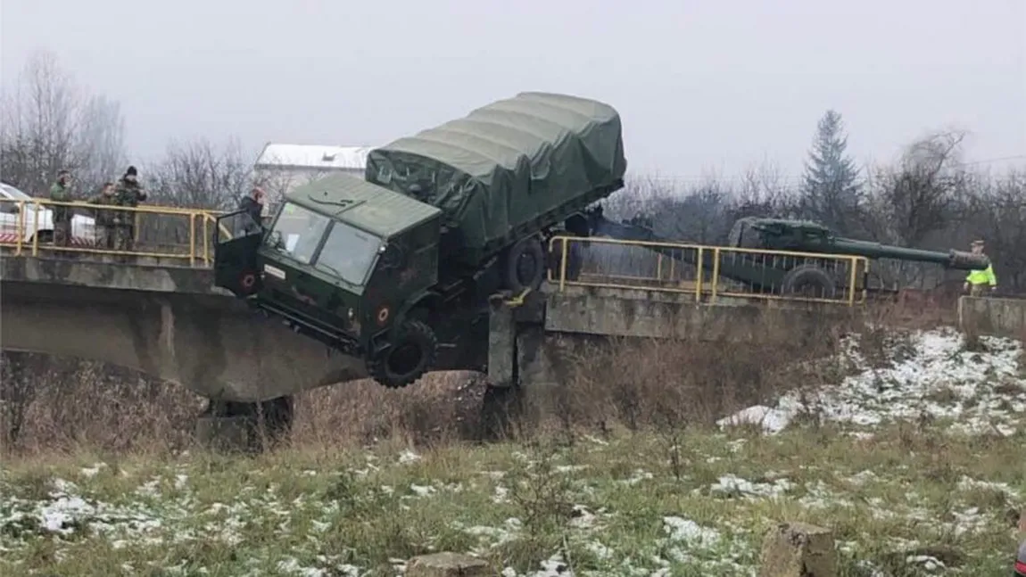 Un camion al Armatei a rămas suspendat de un pod după un accident în Dej. Tunul tractat l-a ţinut să nu cadă