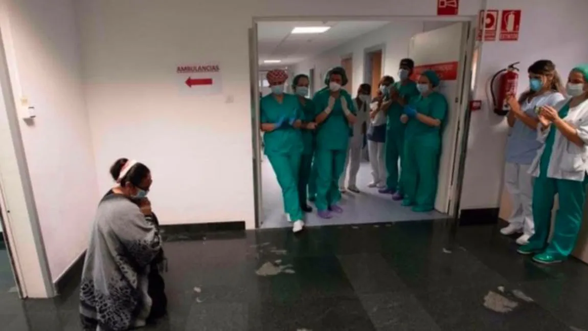 Fotografia anului, în Spania. Mamă din România, în genunchi în faţa medicilor, după ce fiul ei a stat două luni la ATI din cauza COVID