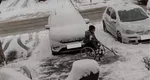 O adevărată lecție de viață. Un bărbat din Făgăraș, imobilizat în scaunul cu rotile, curăță zăpada de pe trotuar: „A ales abilitatea din dizabilitate”