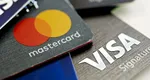 Probleme pentru toți românii care au card Visa sau Mastercard. Cum sunt afectați de războiul comercial al lui Trump