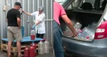 Coadă de zeci de persoane pentru suc de roșii, la Buzău. Localnicii cumpără direct de la fabrica de conserve, cu bidonul: „E foarte bun, ieftin, pentru că asta se caută. Prețul e de vreo patru ani la fel”