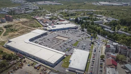 Gigantul străin care face valuri în România. Cumpără pe bandă rulantă și promite investiții masive în țara noastră