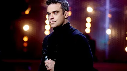 Robbie Williams, luat prin surprindere de un fan cu pantalonii în vine. Vezi reacţia artistului FOTO