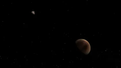 Prima fotografie color a planetei Pluto şi a satelitului său