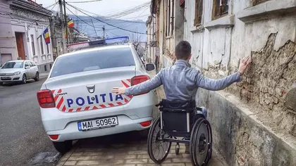 Un bărbat în scaun cu rotile, pus în pericol din cauza unei maşini de poliţie care a blocat tot trotuarul. Reacţii dure pe internet