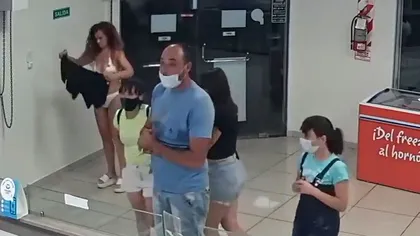 O femeie s-a dezbrăcat de rochie ca să o folosească pe post de mască într-un magazin, sub privirile şocate ale clienţilor şi angajaţilor. VIDEO