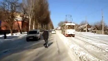 Un PAS în plus l-ar fi lăsat fără PICIOARE: Un PIETON scapă de ROŢILE TRAMVAIULUI datorită zăpezii VIDEO