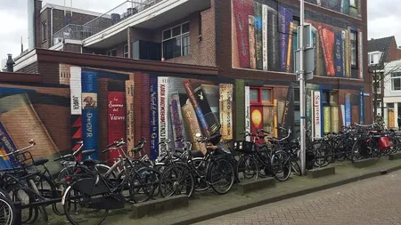 Un artist stradal olandez a creat un grafitti spectaculos cu ajutorul locuitorilor unui bloc FOTO