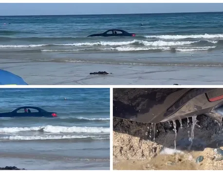 BMW înghițit de valurile mării, după ce un șofer a parcat mașina pe plajă: „Nu poți parca acolo, amice”