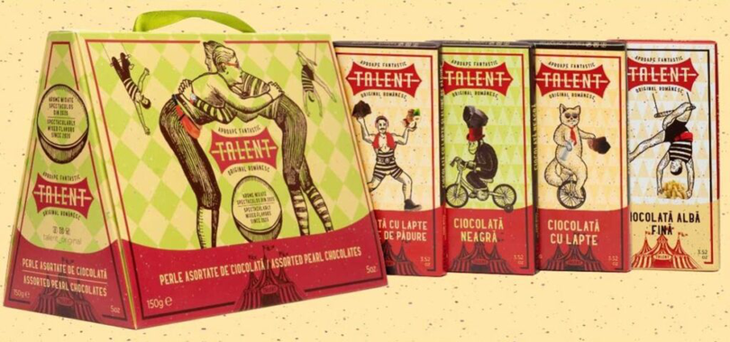 Portofoliul include tablete de ciocolată cu lapte, albă și neagră, dar și sortimente cu ingrediente premium, precum alune de pădure, fistic, caramel sărat sau migdale, alături de o selecție de praline.