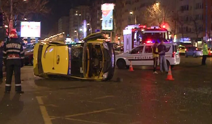 Accident grav în Bucureşti: Un taxi a fost răsturnat de o şoferiţă care a trecut pe roşu