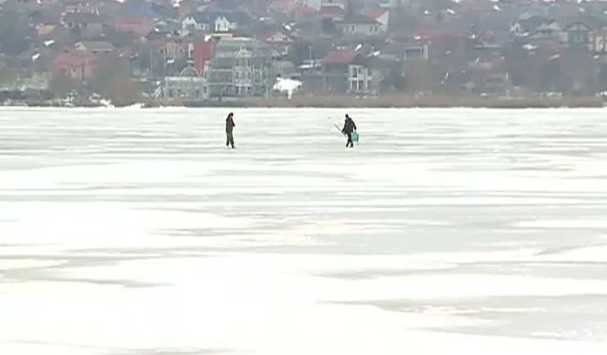 Distracţie periculoasă pe lacul îngheţat. Patru tineri s-au aventurat pe gheaţa care se topeşte