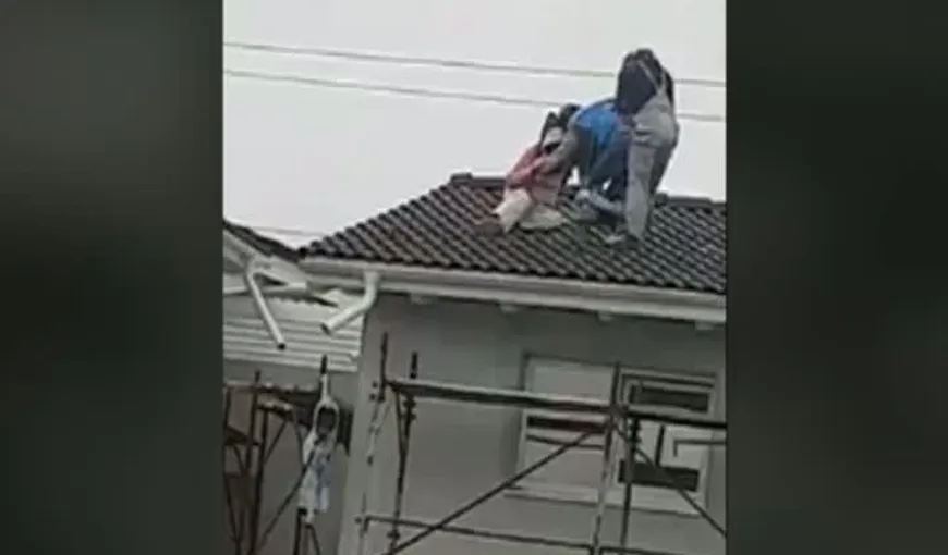 Trei muncitori beţi au fost filmaţi pe acoperişul unui bloc în timp ce încercau să coboare VIDEO